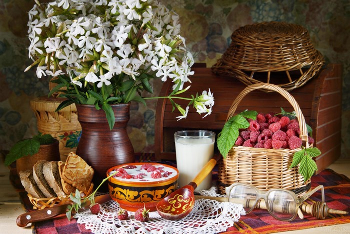 Still-life with raspberries, milk, bread, and flowers