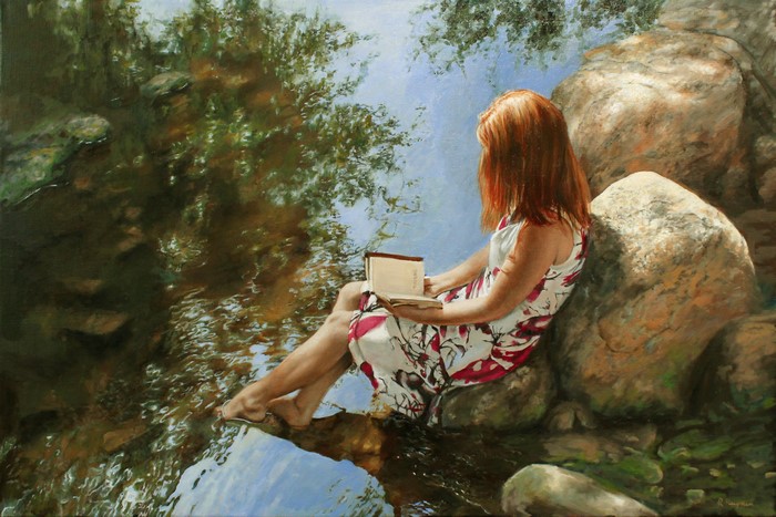 Woman reading by a stream