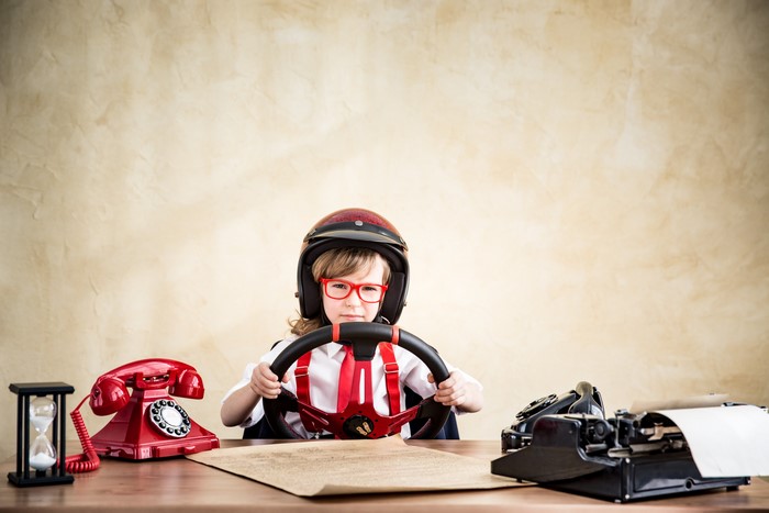 Boy in Helmet and Glasses with Steering Wheel