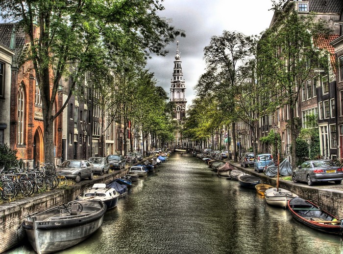 Canal in Amsterdam with boats and tower