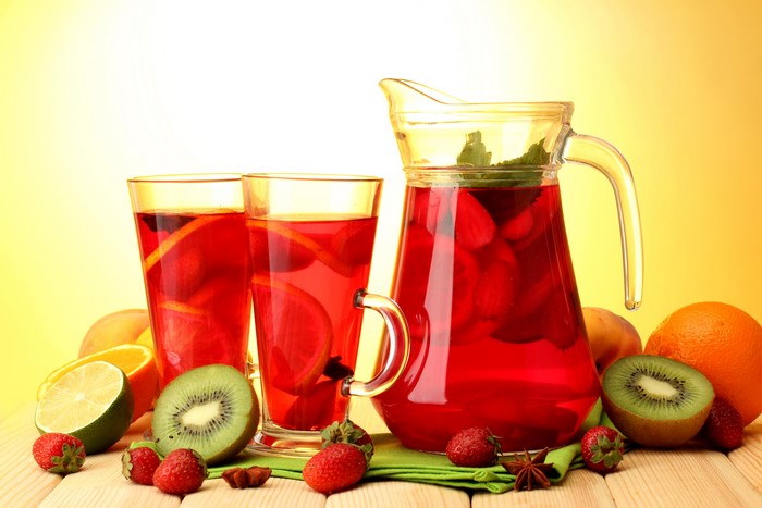 Juice with fruits in glasses and pitcher