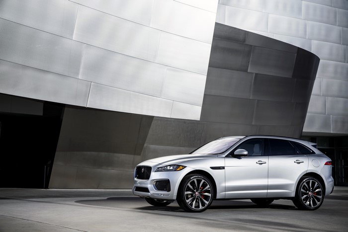 Silver Jaguar F-Pace parked near a modern building