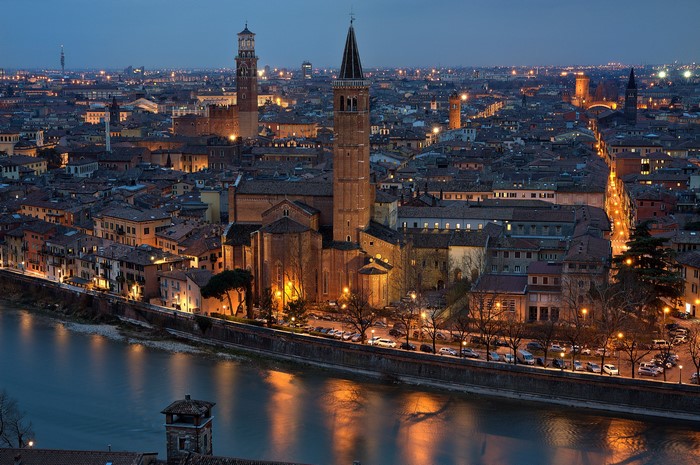 Verona cityscape at night with Adige River and churches
