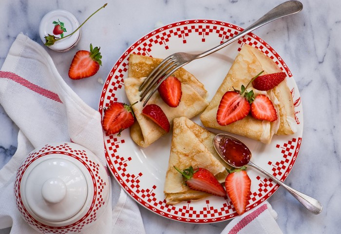 Pancakes with Strawberries and Jam on a Plate