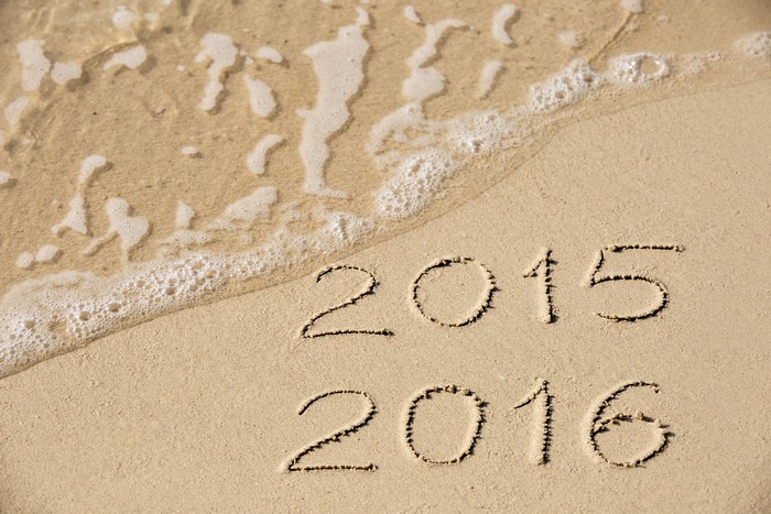2015 and 2016 written in sand with waves