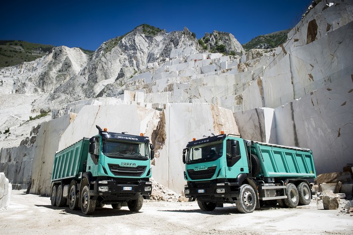 Two IVECO Trakker trucks in a marble quarry