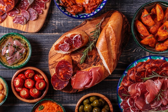 Tapas spread with bread, charcuterie, and olives