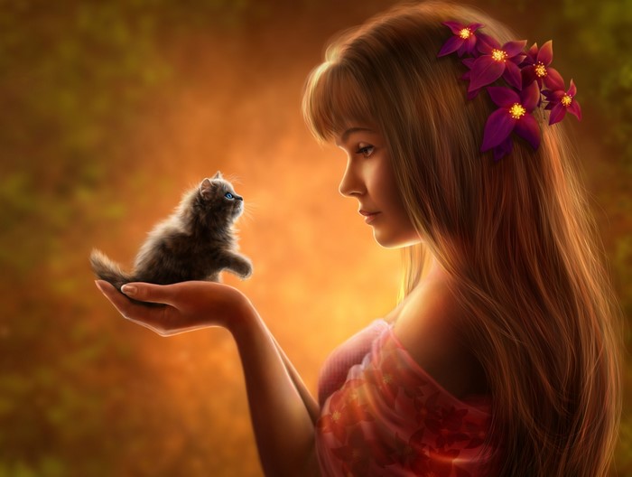 Girl holding a kitten with flowers in her hair
