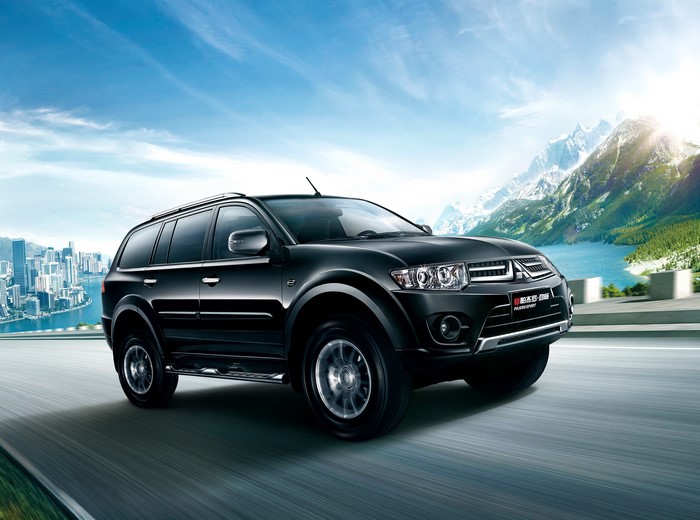 Black Mitsubishi Pajero Sport driving on a road