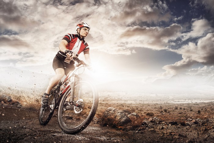 Man riding a bicycle on a dirt path