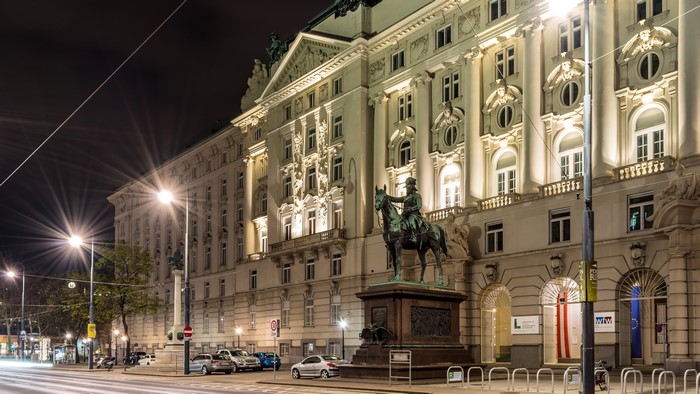 Monument in front of a building at night in Vienna, Austria