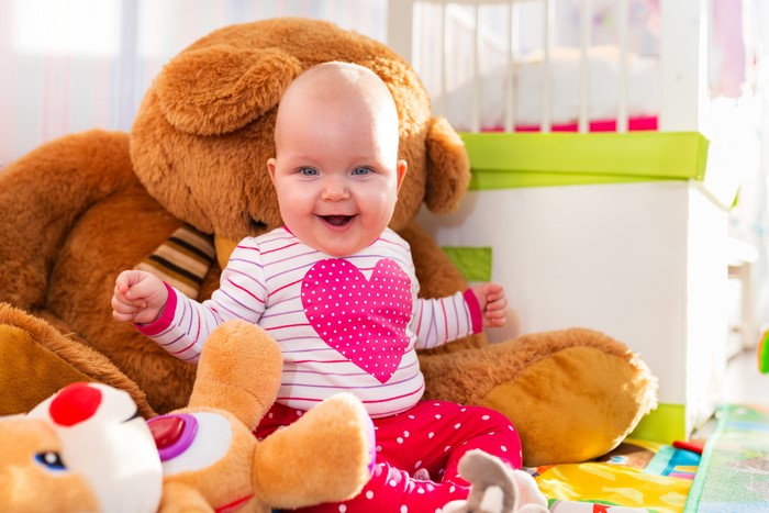Baby with Teddy Bear and Toys