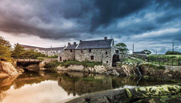 Stone mill building with water wheel by river in Annalong, Northern Ireland