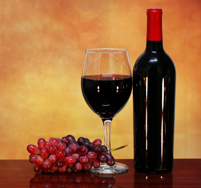 Red wine bottle, glass, and grapes