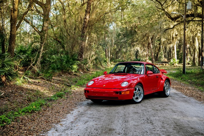Red Porsche 911 on a dirt road