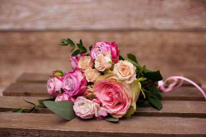 Bouquet of pink and peach roses with greenery