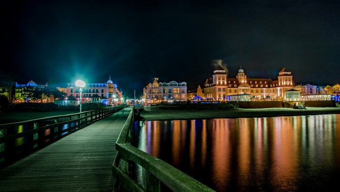 Pier and illuminated buildings at night in Binz, Germany