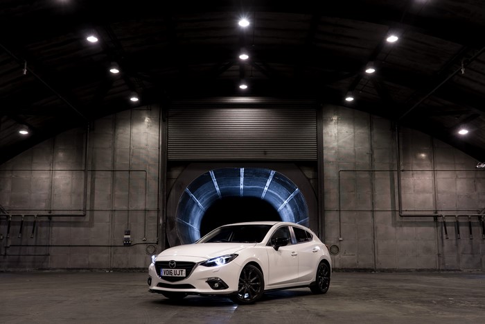 White 2016 Mazda 3 Sport in a large industrial building