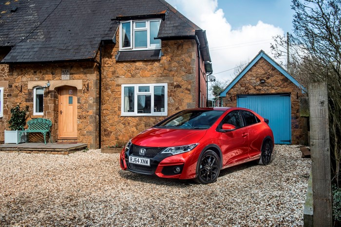Red 2014 Honda Civic in front of a house