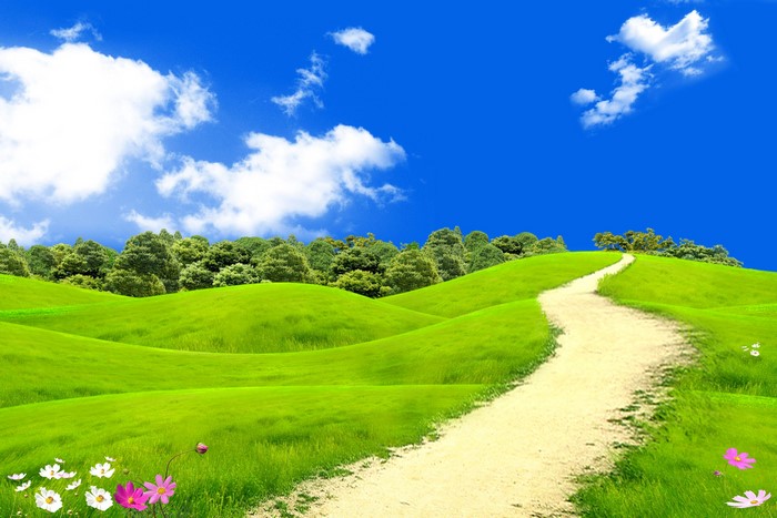 Green rolling hills with a dirt path and blue sky