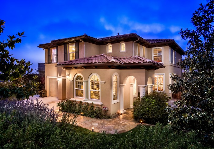 Luxury house at dusk with landscaped garden