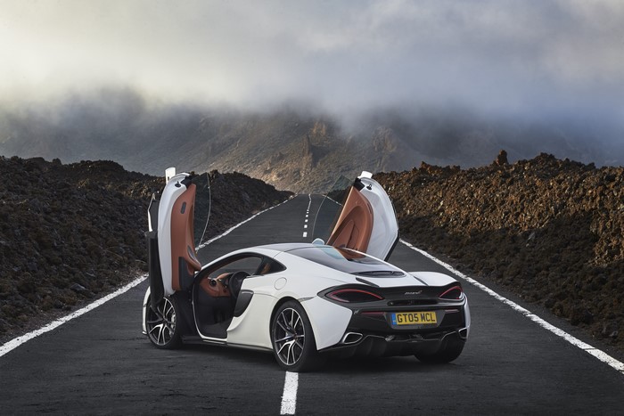 McLaren 570GT with opened doors on a road