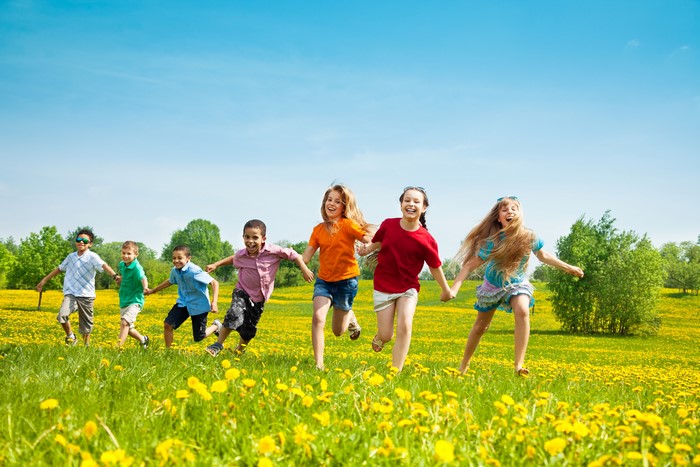 Children Running Through a Field of Dandelions