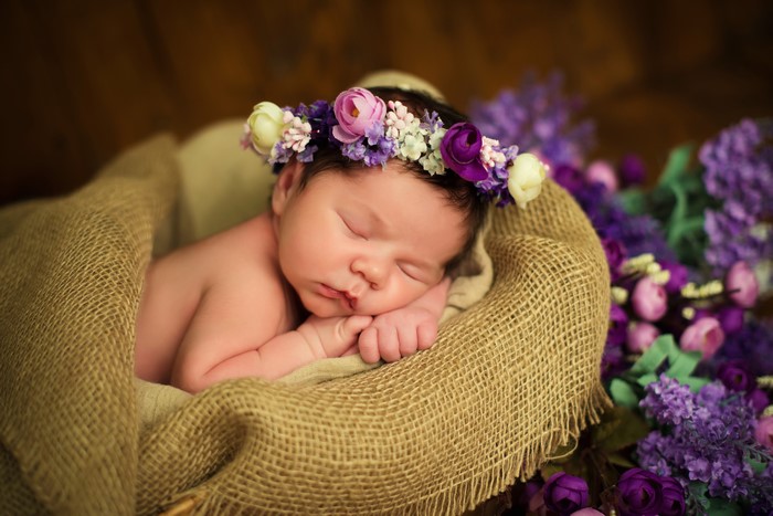Newborn baby sleeping with flower crown