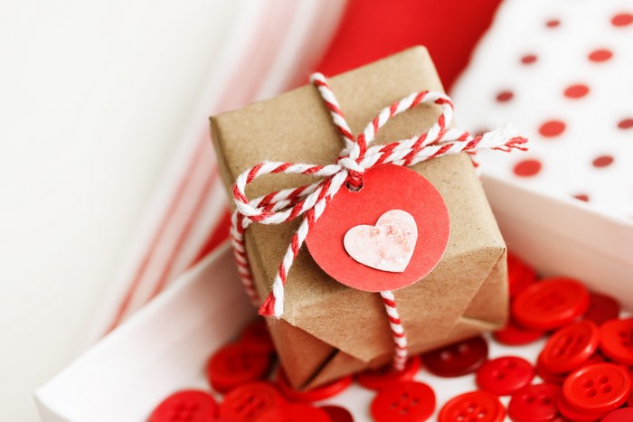 Gift box with heart tag and red buttons