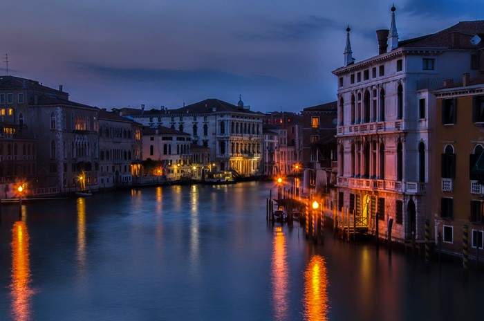 Venice canal at night with illuminated buildings