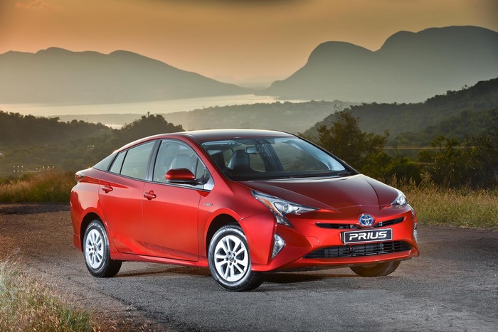 Red 2016 Toyota Prius on a road