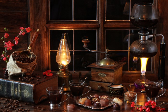 Still-life with coffee, candies, and a kerosene lamp