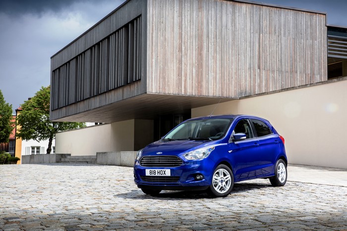 Blue Ford Ka parked in front of a modern building