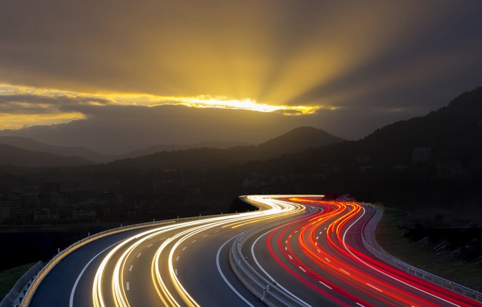 Highway light trails at sunset