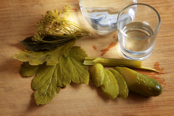 Vodka, Cucumbers, Dill, and Leaves on a Cutting Board
