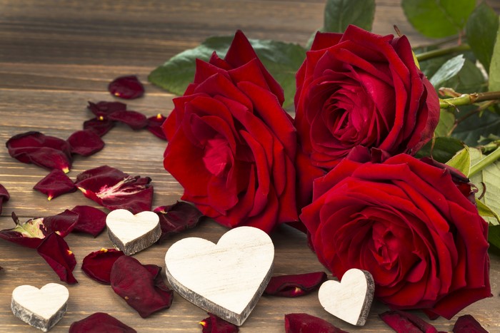Red Roses and Heart Decorations on Wooden Surface