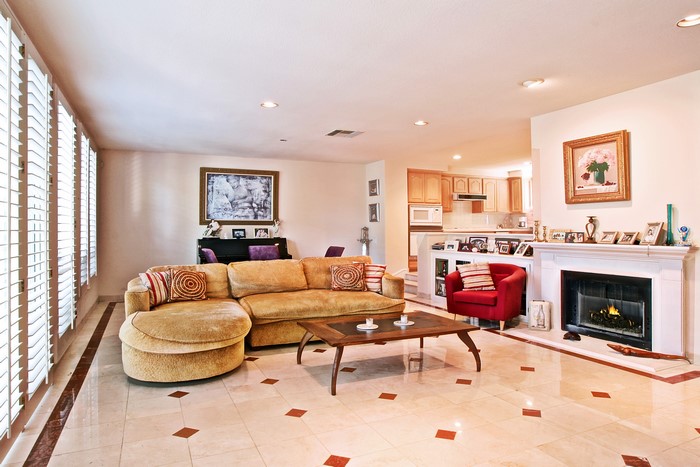 Living room with fireplace, sofa, and piano