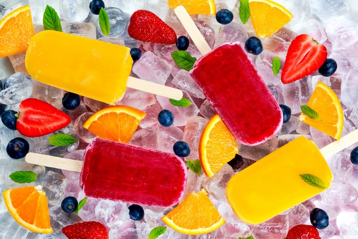 Assorted Popsicles with Fruits on Ice