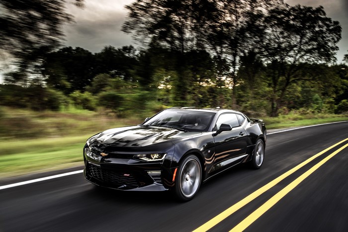 Black Chevrolet Camaro SS driving on a road