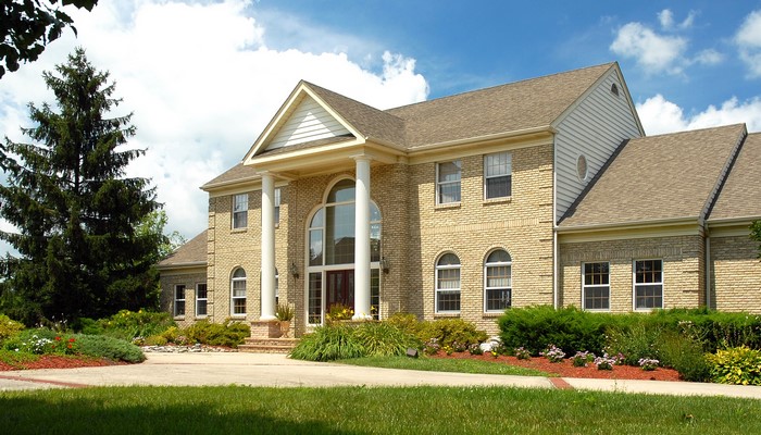 Large brick house with manicured landscaping