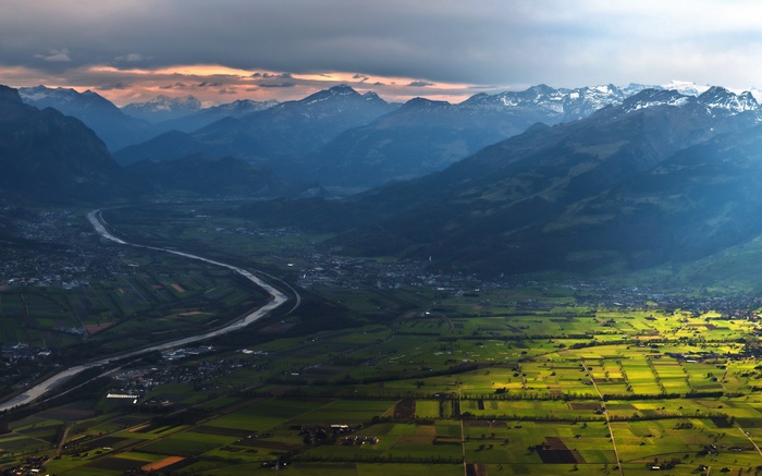 Valley with river and mountains at sunset
