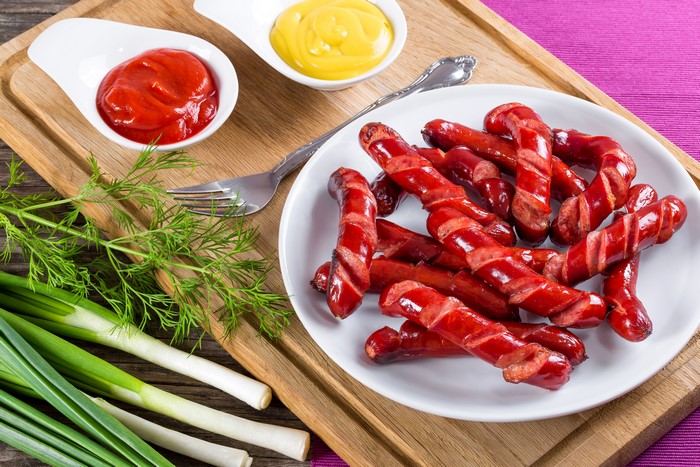 Spiral cut sausages with ketchup and mustard