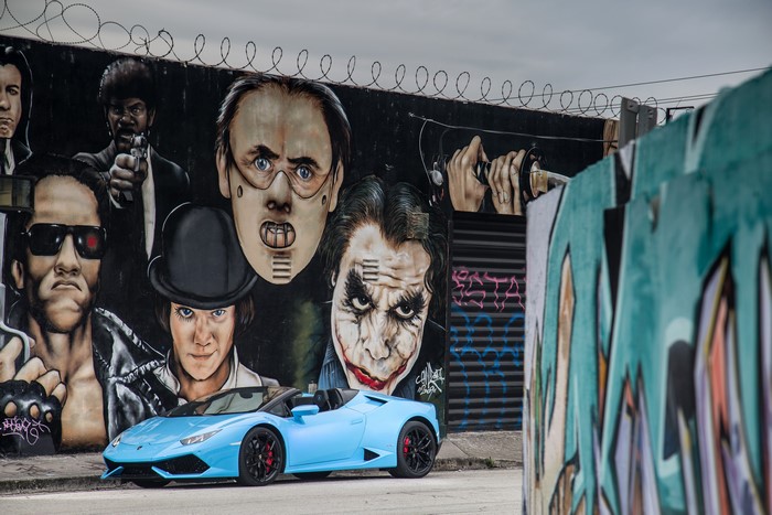 Light Blue Lamborghini Cabriolet in front of Movie Character Graffiti