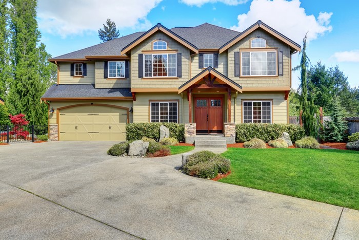 Luxury two-story house with garage and manicured lawn