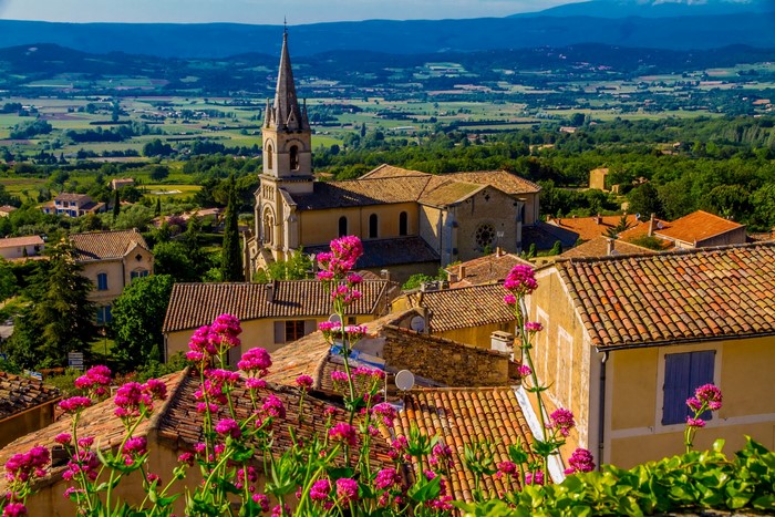 Bonnieux, France village with church and flowers