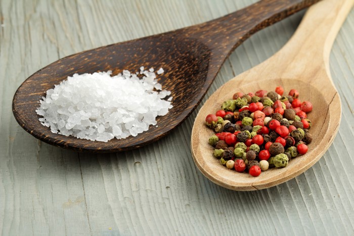 Salt and Peppercorns on Wooden Spoons