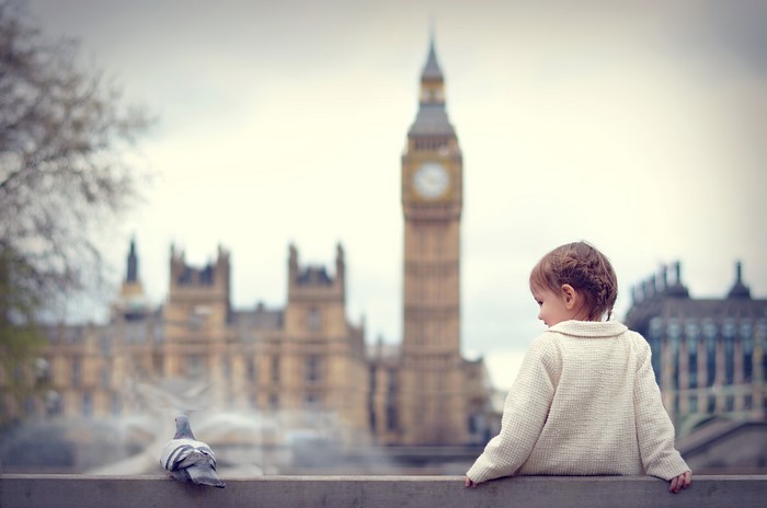 Little girl and pigeon with Big Ben in London
