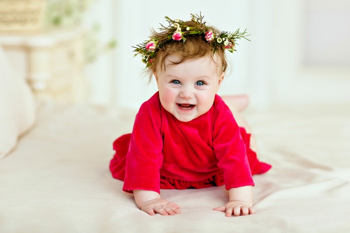 Baby wearing a flower crown and red dress