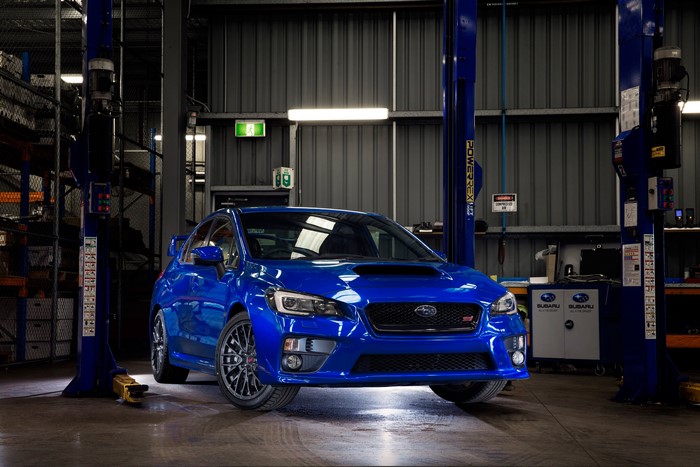 Blue Subaru WRX STI in a garage