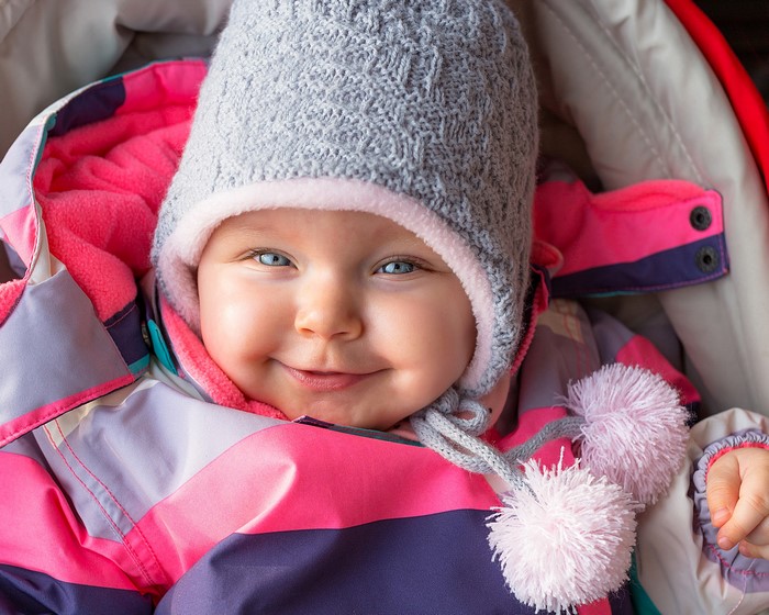 Baby wearing a winter hat and snowsuit